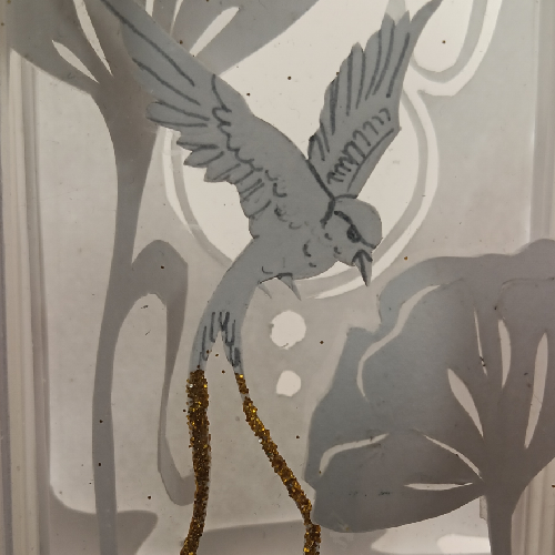 Une lightbox artisanale unique, entre lumière, nature et rêverie. détail oiseau lampe allumée